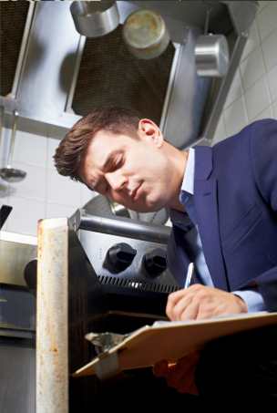 Professional inspector examining commercial kitchen equipment with clipboard, ensuring compliance and safety standards