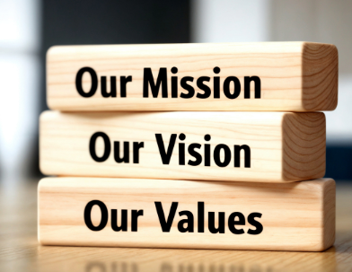 Our Mission, Our Vision, Our Values foundational principles displayed on wooden blocks